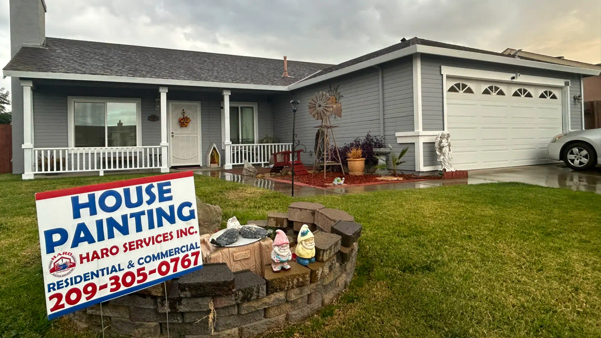 newly painted residential house with haro services inc promotional card